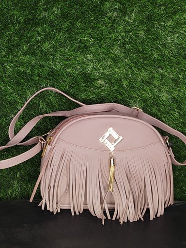 This mauve/dusty pink faux leather crossbody bag features a stylish design perfect for daily use or special occasions.